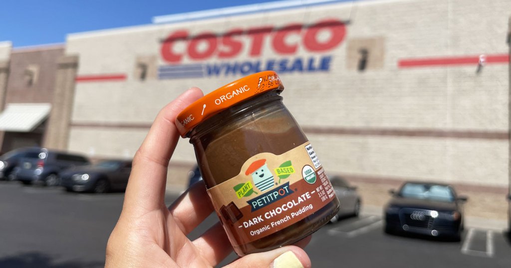 holding up jar of pudding in front of costco