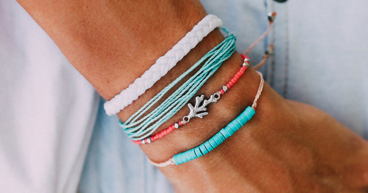 woman wearing a variety of bracelets