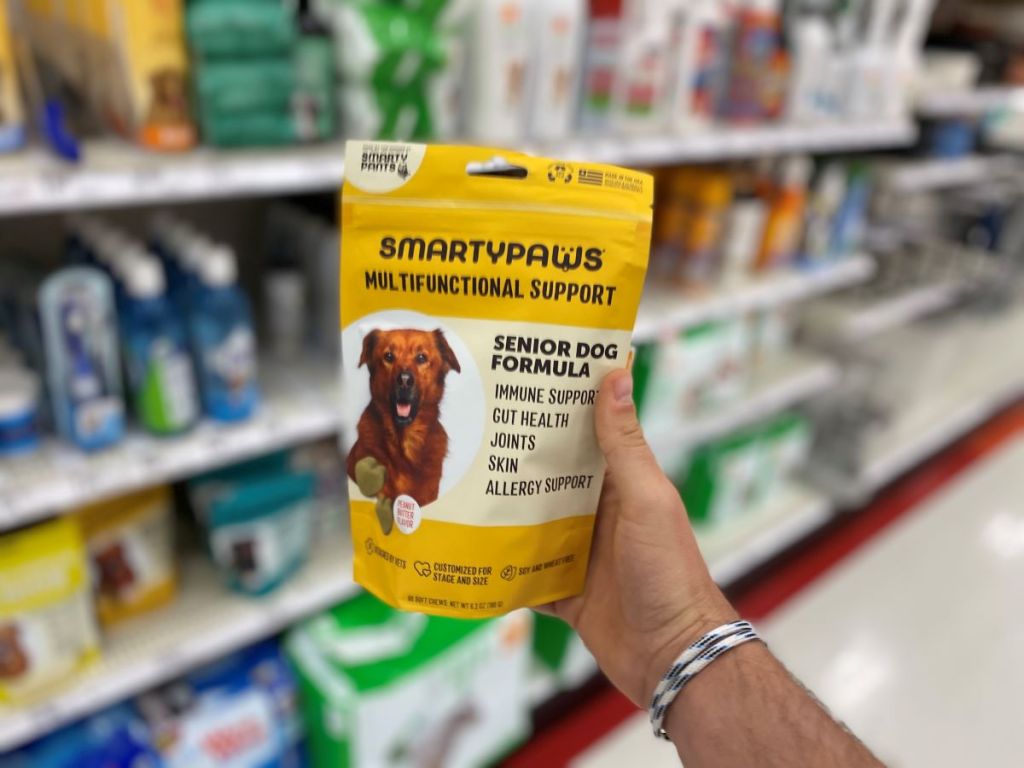 hand holding a bag of SmartyPaws Senior supplements