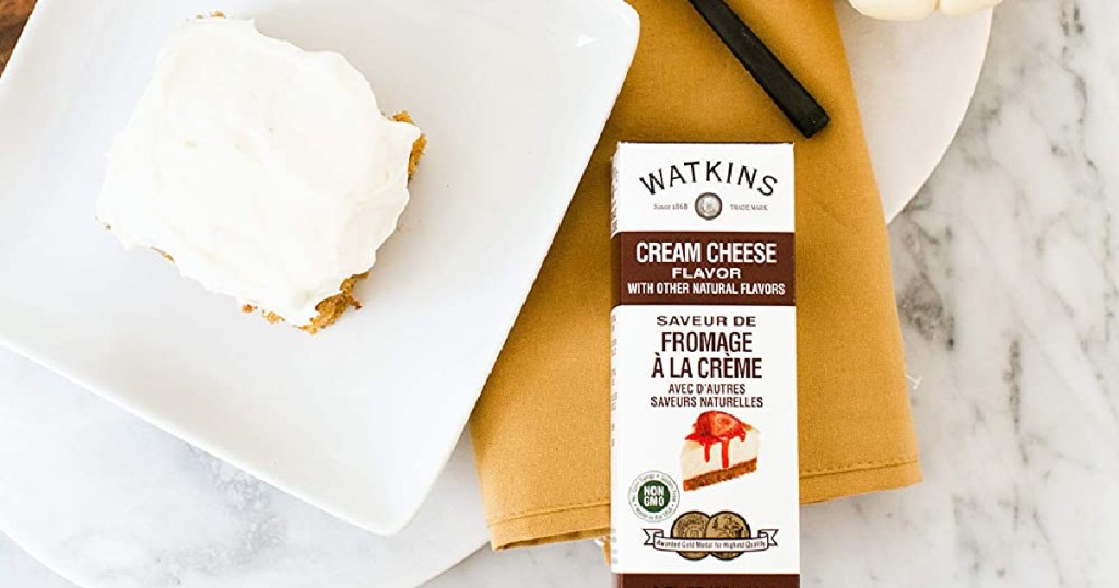 Watkins Cream Cheese next to cheesecake on a plate