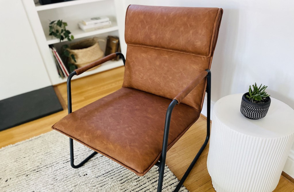 close up of brown leather accent chair in living room