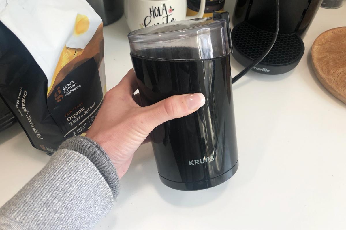 woman holding coffee grinder