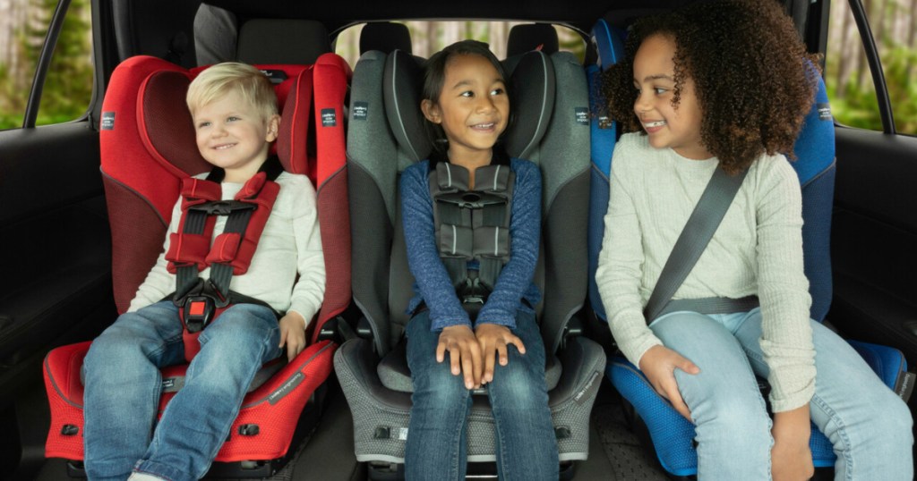 three children in backseat of car in carseats