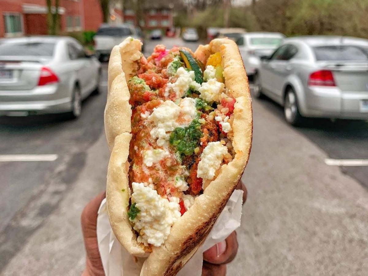 tax day freebie - holding a pita wrap on the street