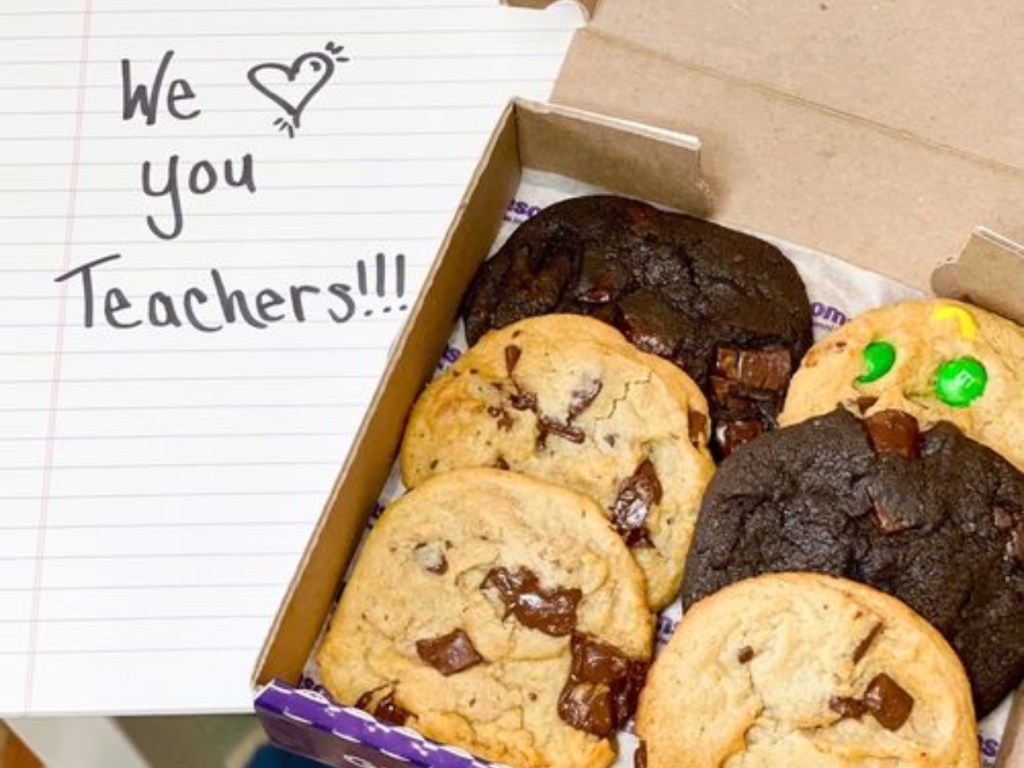 6-pack of Insomnia cookies next to notebook