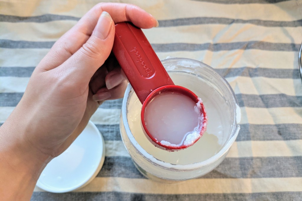 oil in tablespoon over jar for oil pulling