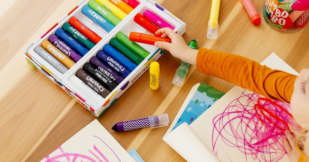 girl reaching for paint stick