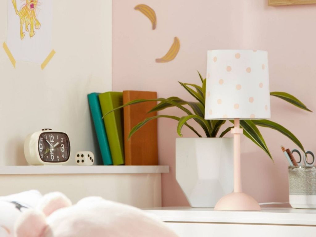 pink and white polka dot lamp in kids room