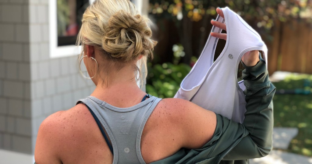 woman holding lululemon and dupes