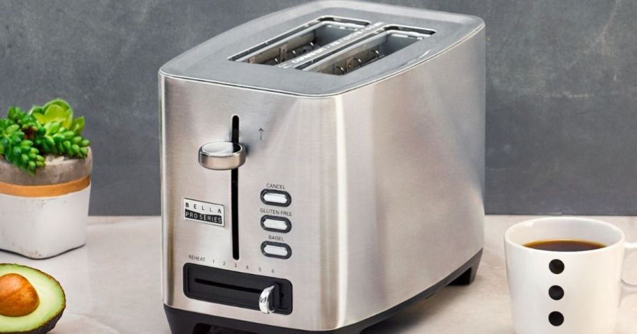 toaster sitting on a counter with coffee next to it