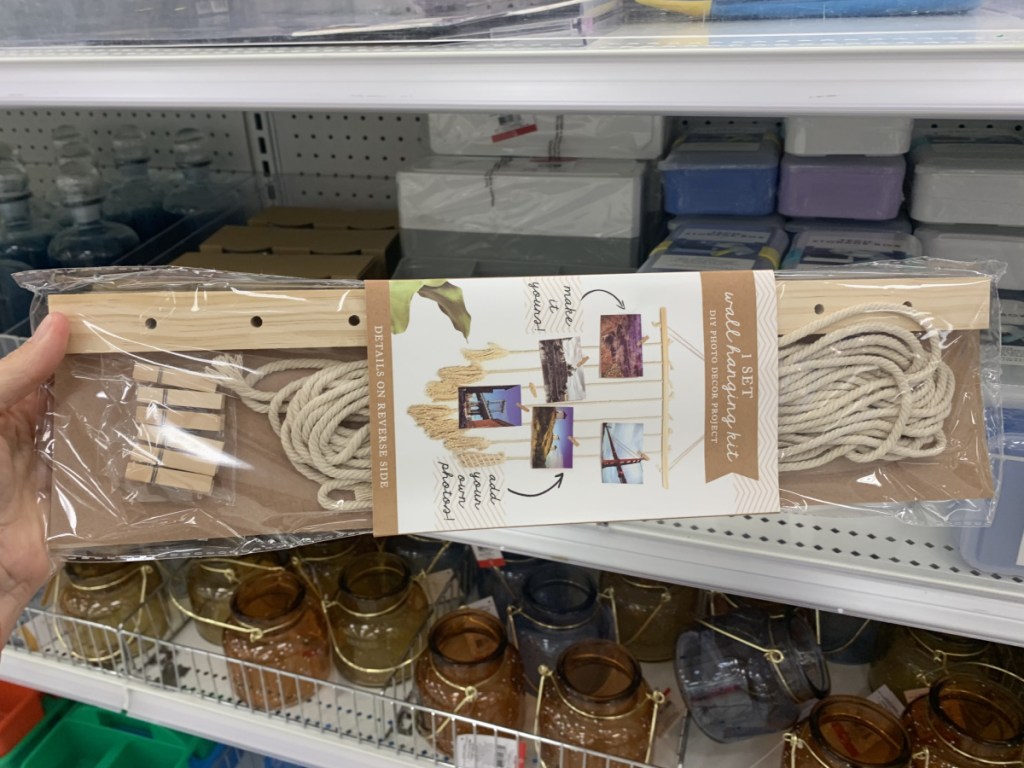 Hand holding a DIY photo hanger project in packaging