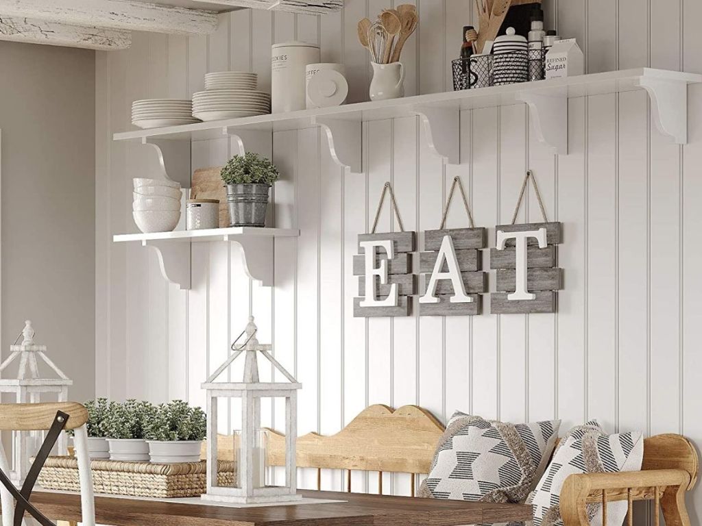 E A T sign hung on dining room wall