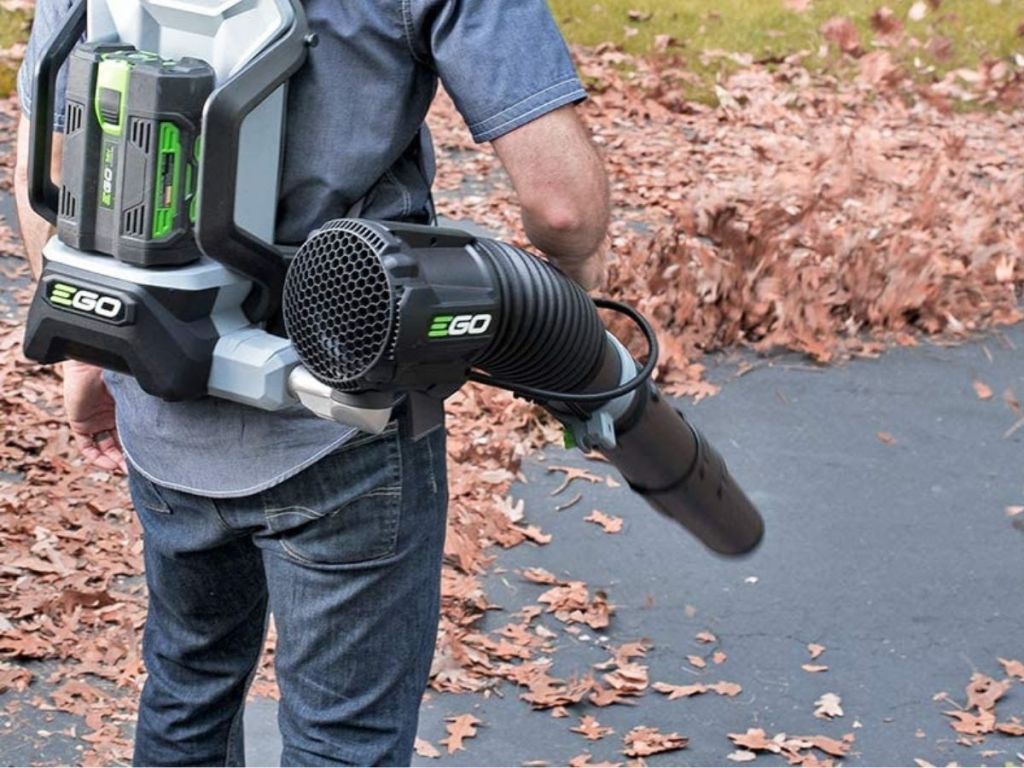 man wearing leaf blower backpack