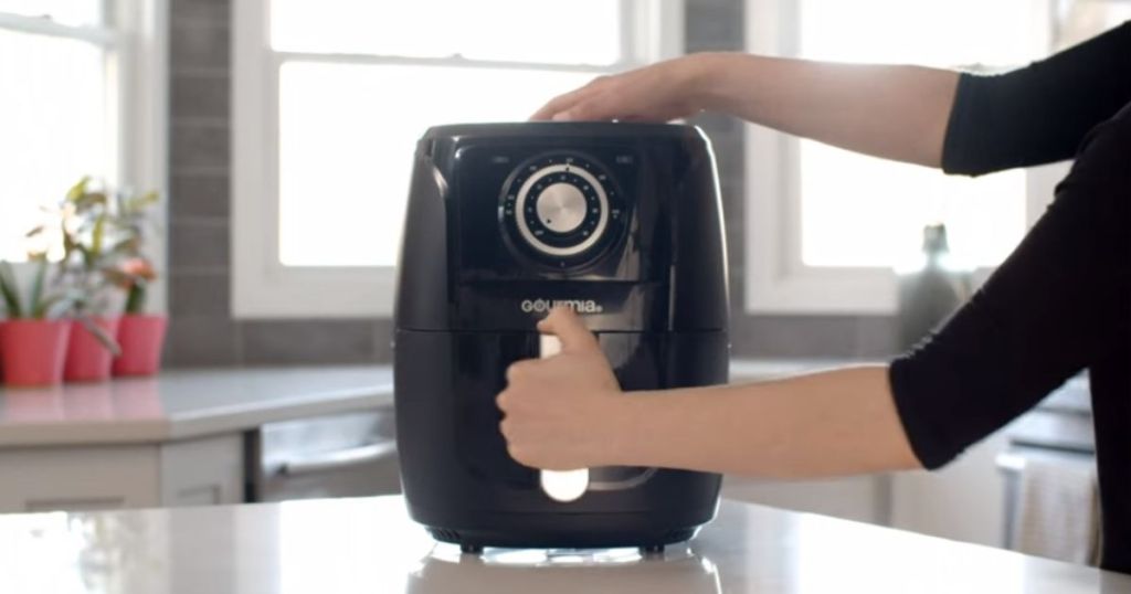 person holding onto an air fryer