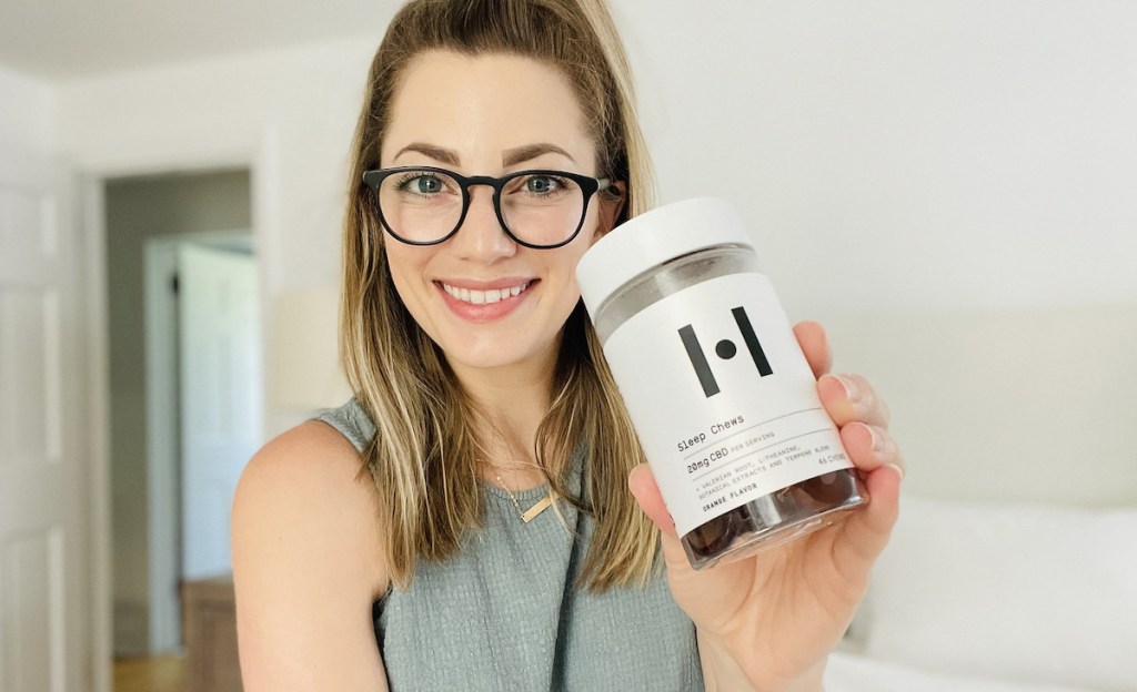 woman holding bottle of healist CBD gummies