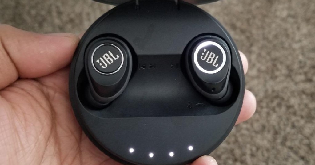 hand holding jbl wireless earbuds