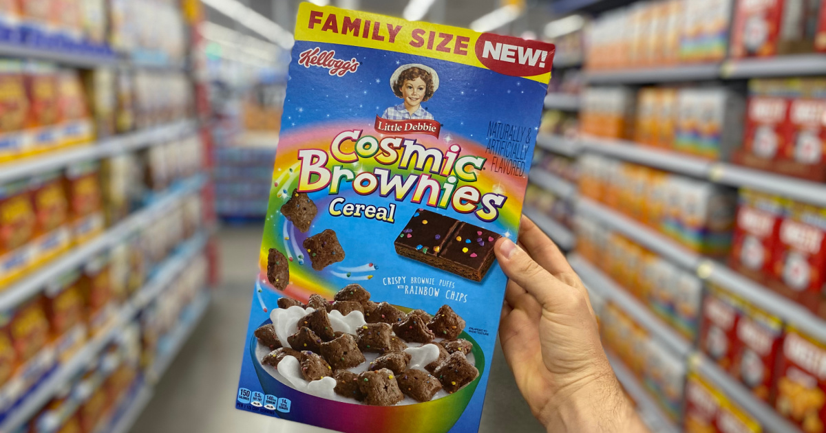 hand holding up a family size box of little debbie cosmic brownies cereal in a store aisle