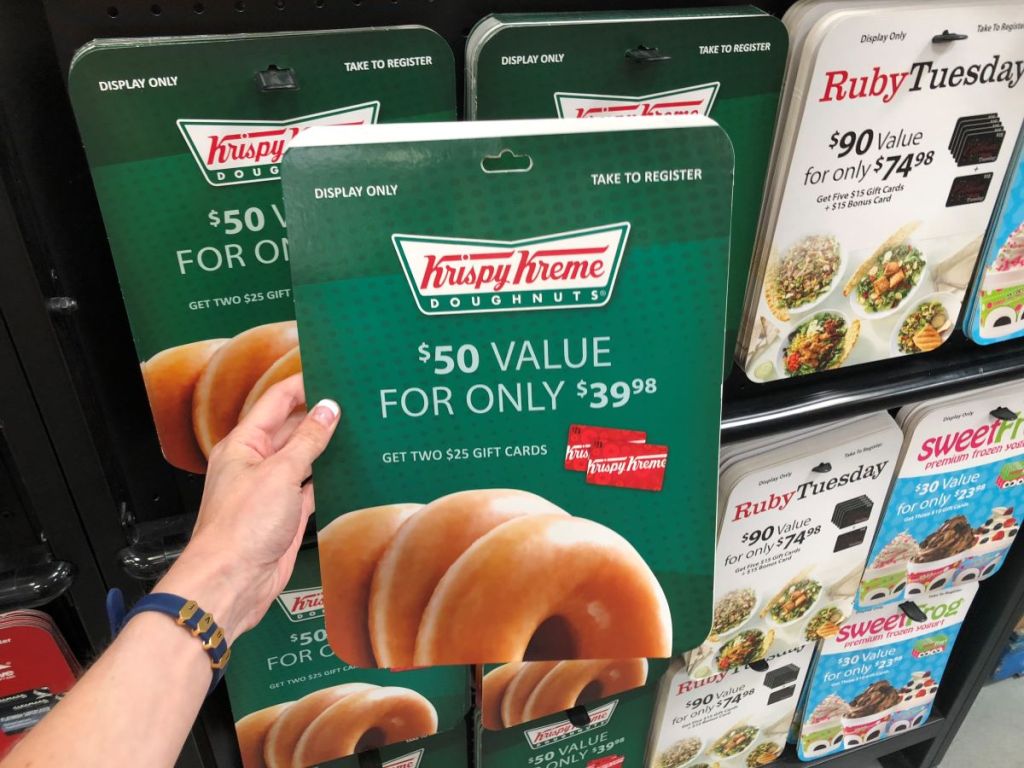 hand holding a Krispy Kreme Gift Card at Sam's Club