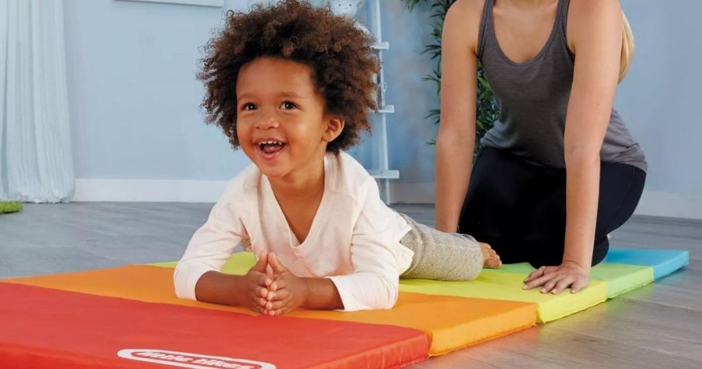 kid laying on a play mat