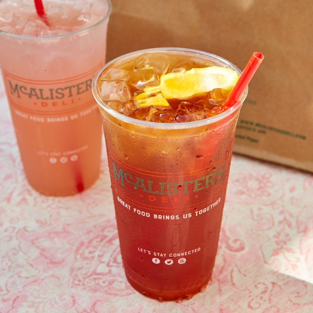 Large cup full of tea and ice with lemon wedge on top