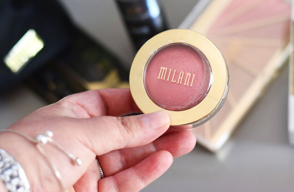 woman holding milani blush