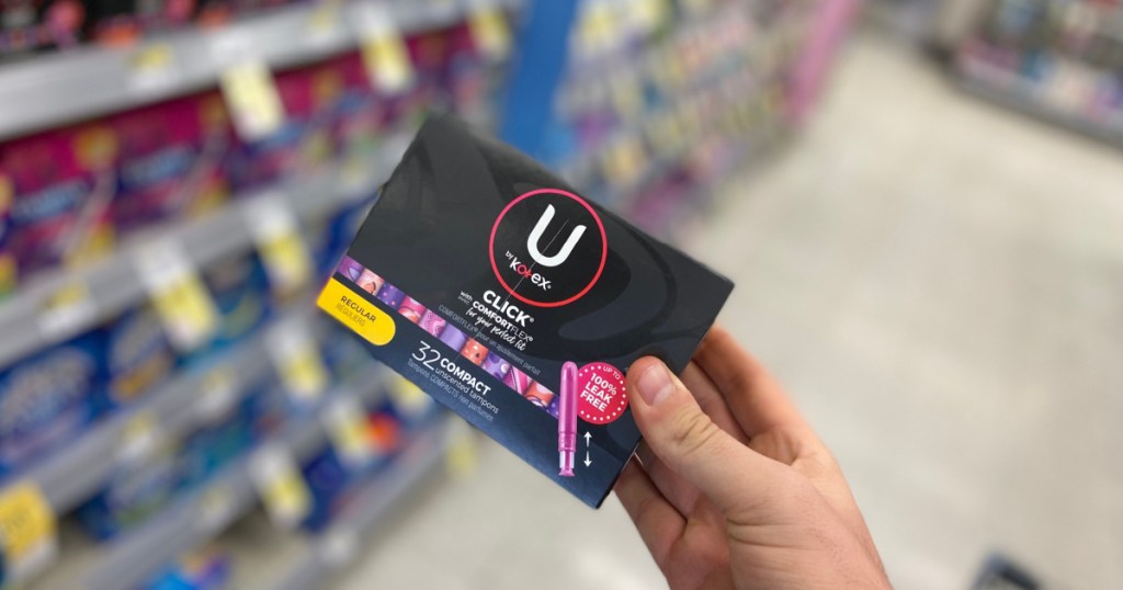 hand holding black box of feminine care products 