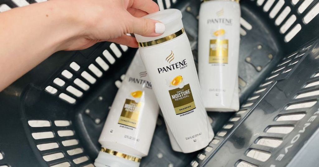 hand holding a bottle of Pantene