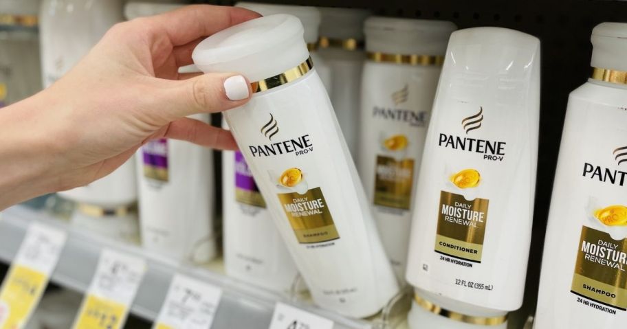 hand holding a bottle of Pantene