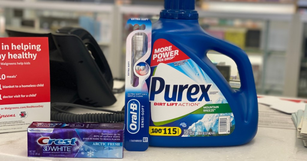 toothpaste, toothbrushes and detergent on counter 