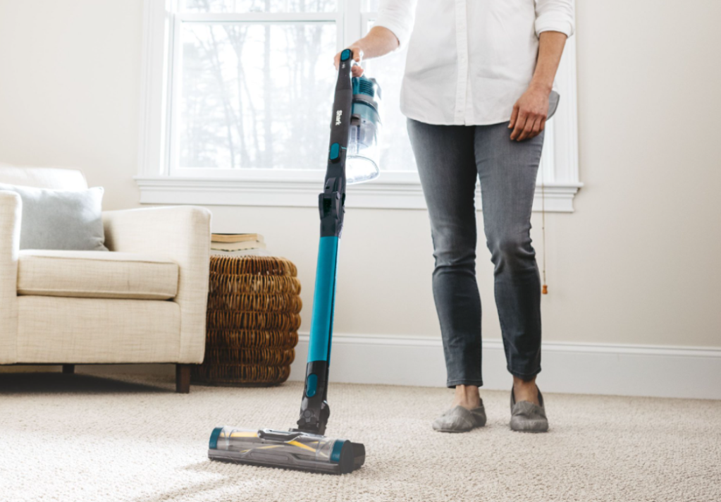 woman using a Shark vacuum