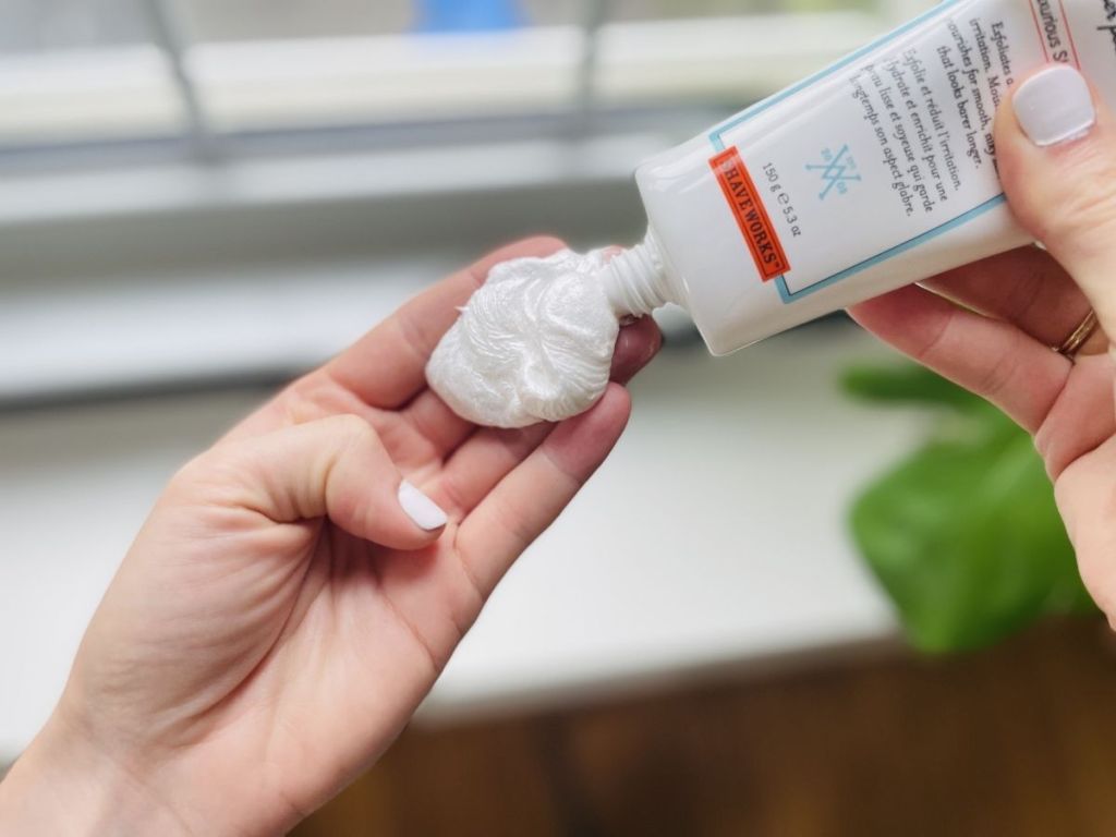 woman squeezing Shaveworks shaving cream into hand