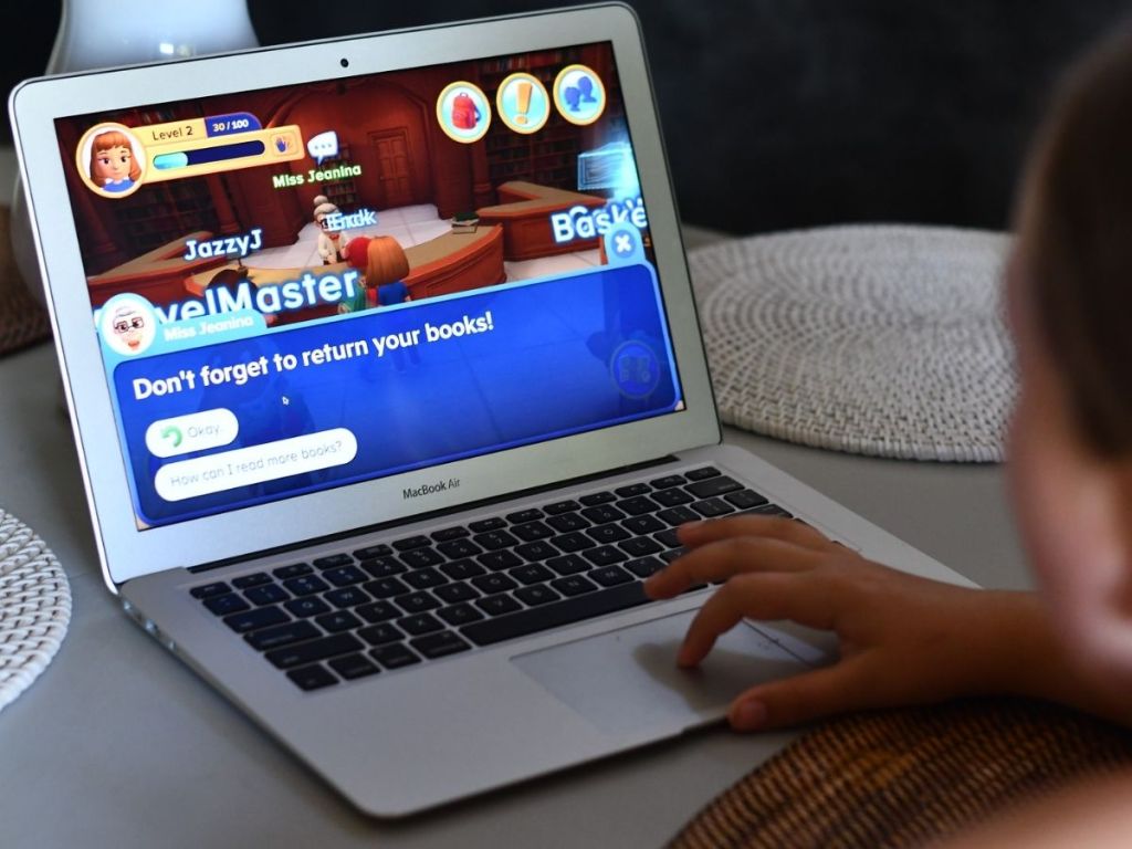 child playing computer game on laptop