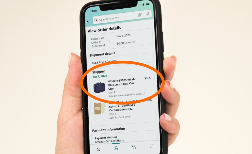 hand holding phone with amazon lunch box order on screen