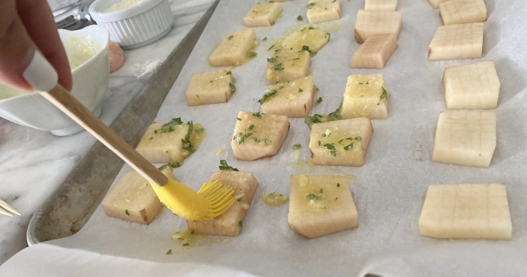 brushing parmesan oil on potatoes