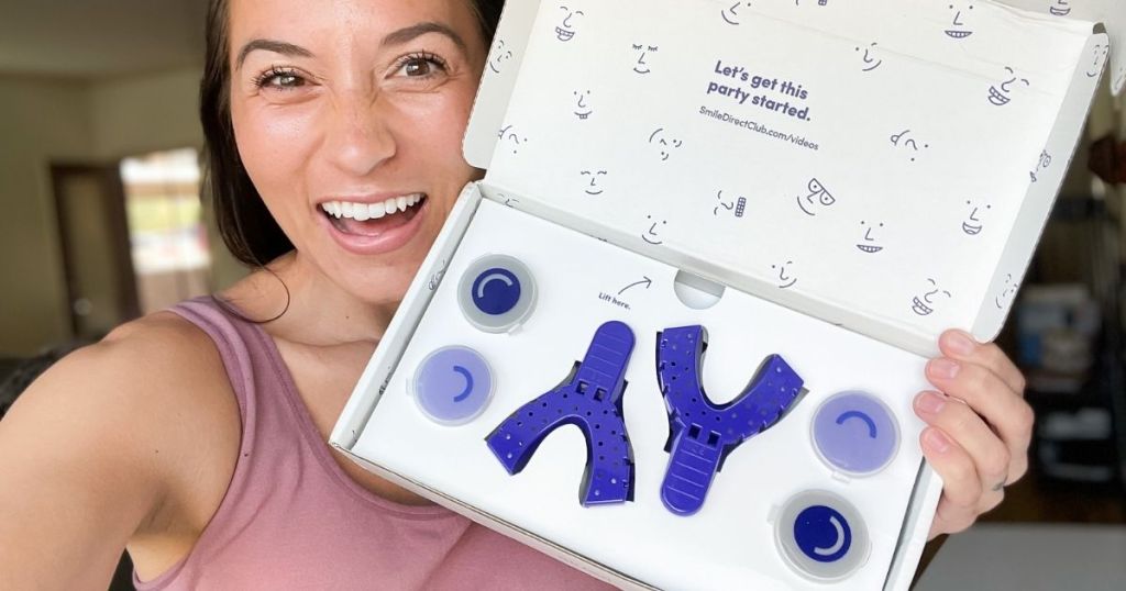 woman holding a box of impression trays from Smile Direct Club