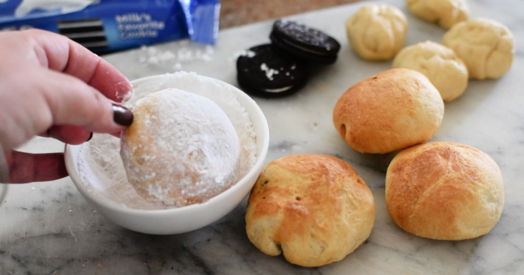 dipping fried oreos in powdered sugar