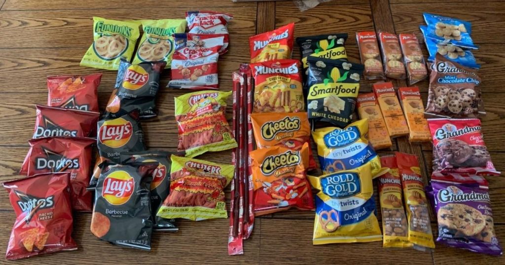 lots of frito-lay brand snacks on table