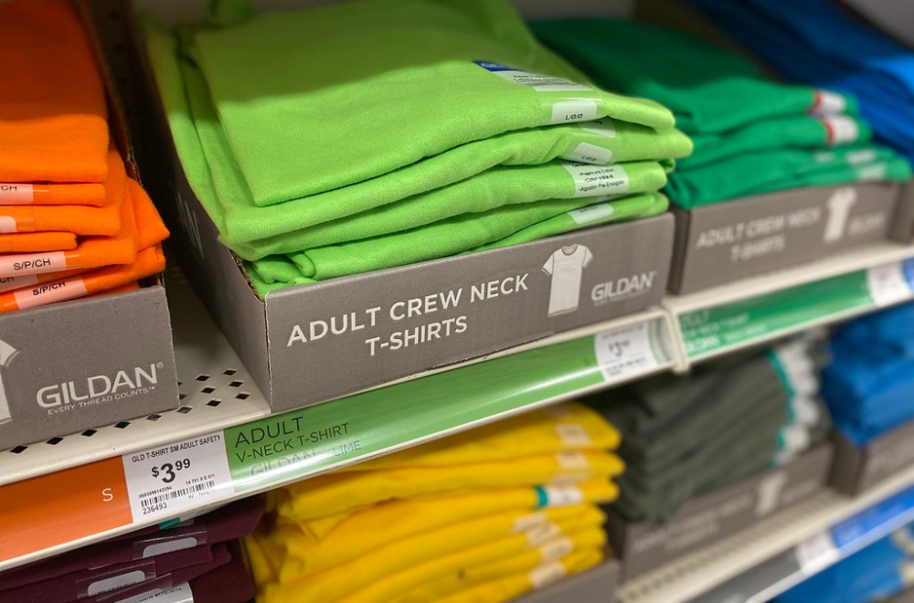 solid color tees on a store shelf display