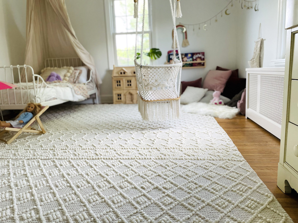 little girls bedroom with cream boho area rug 