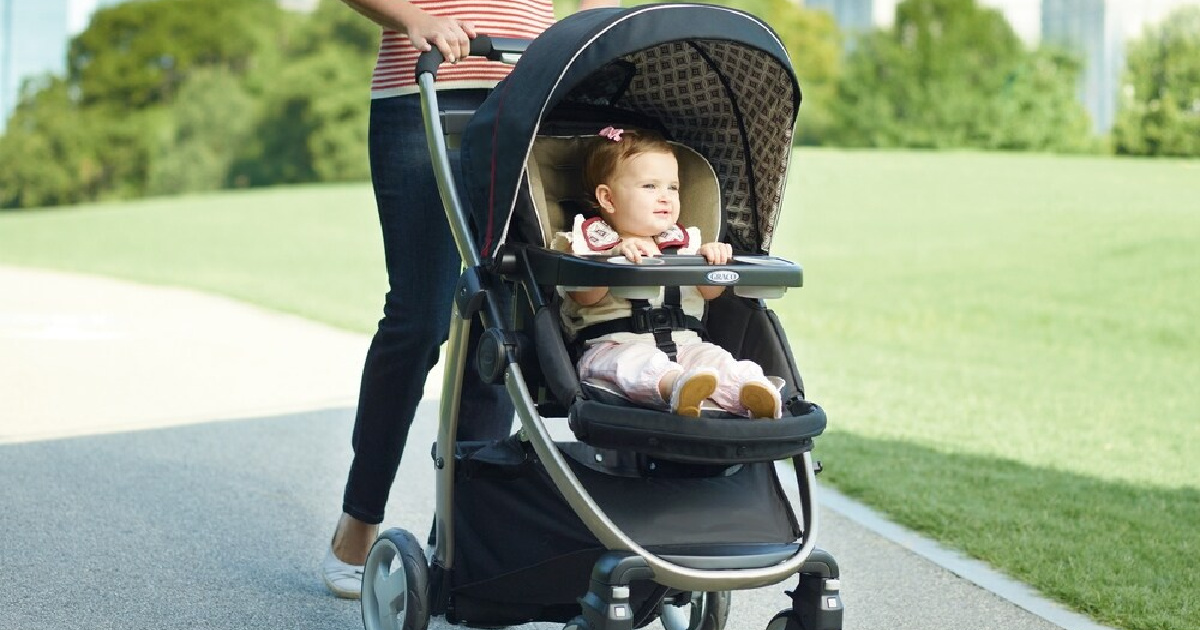 woman pushing a baby in a stroller outside