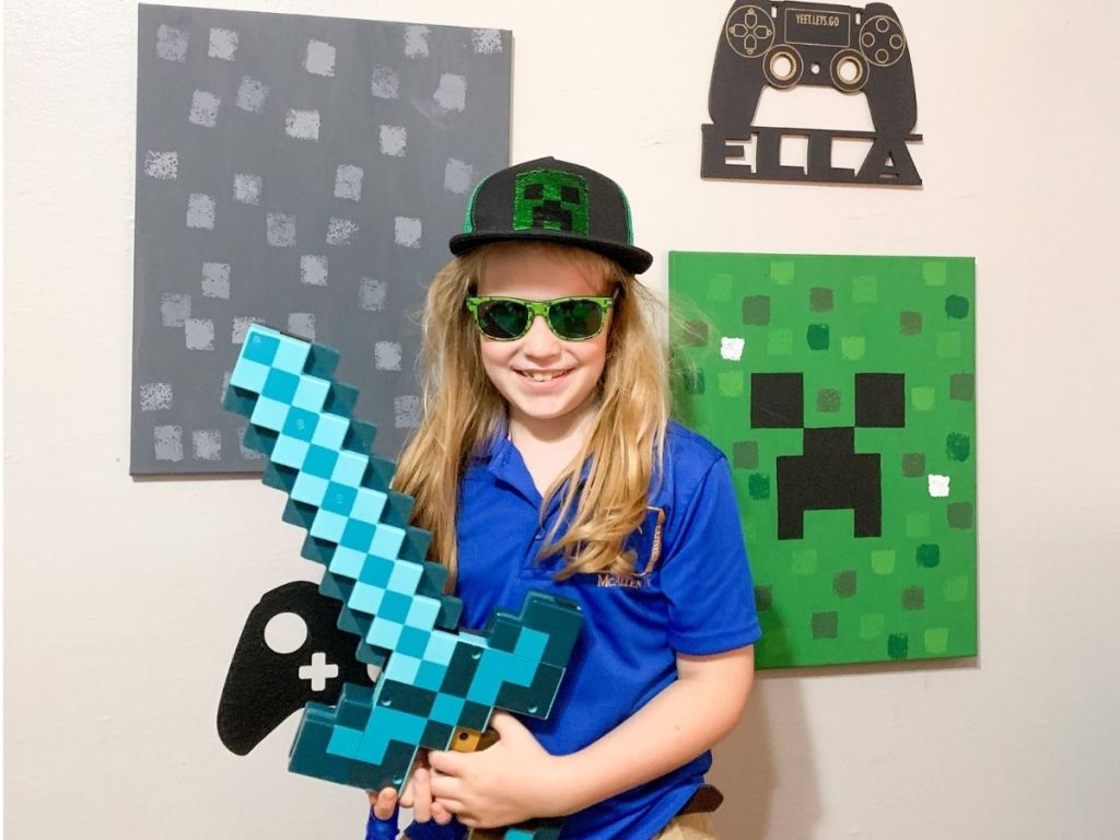 girl wearing Minecraft gear standing in front of Minecraft wall decor