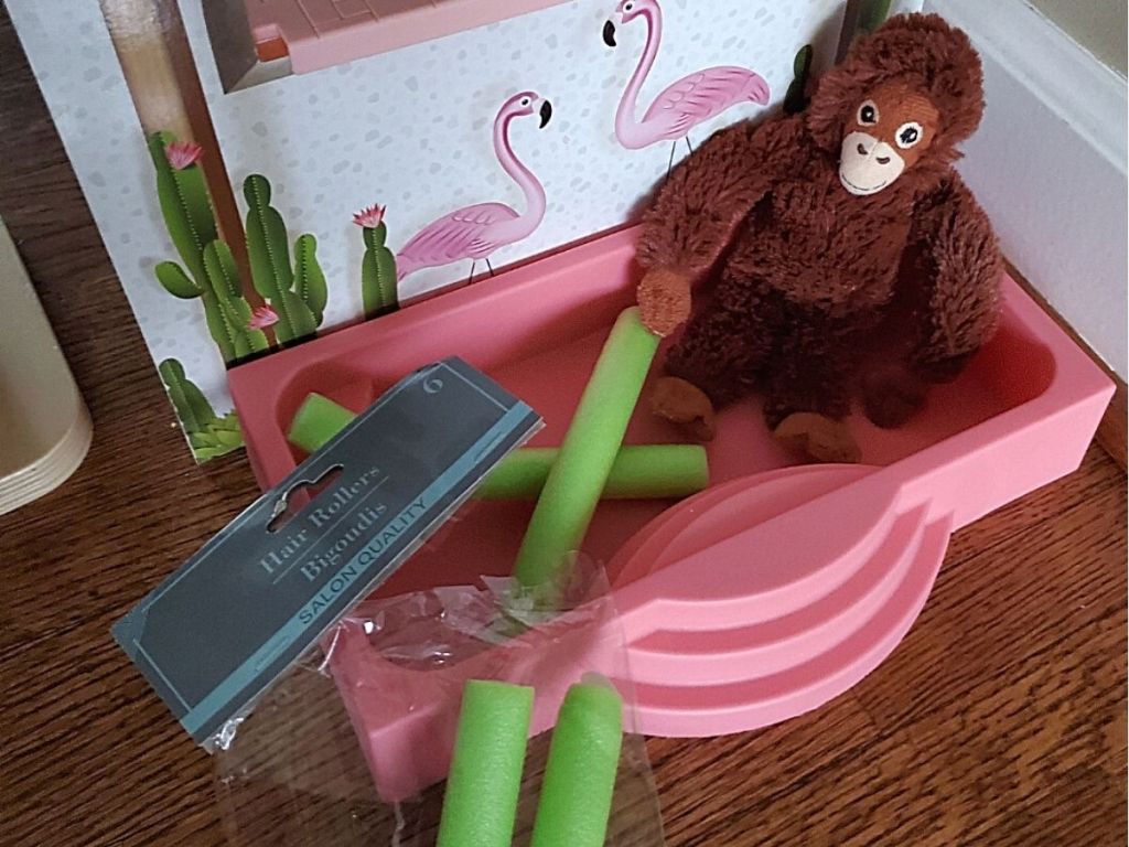 toy plush monkey using pool noodles in toy pool