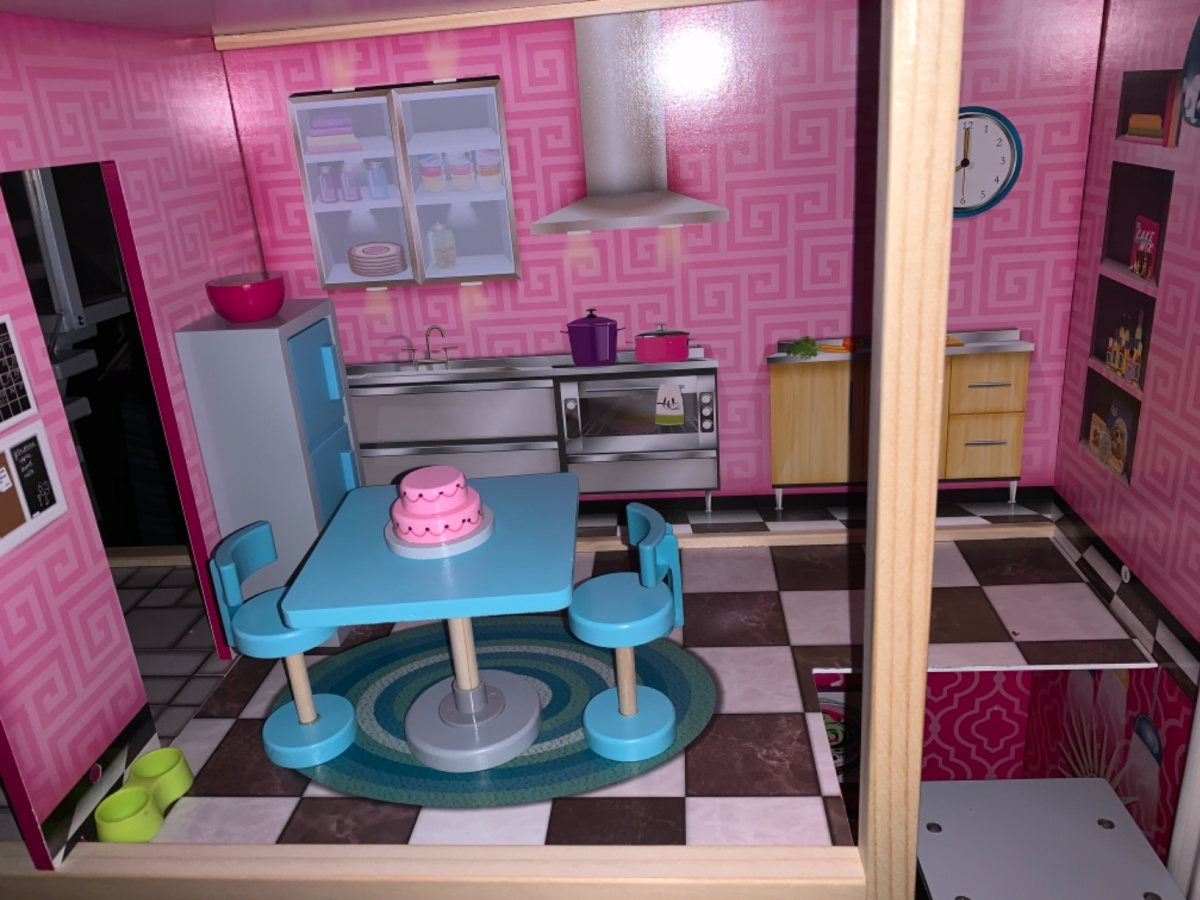 room in dollhouse with cake and kitchen table