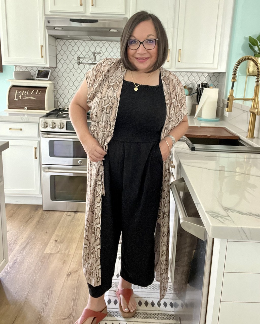woman wearing bathing suit cover up with black jumper