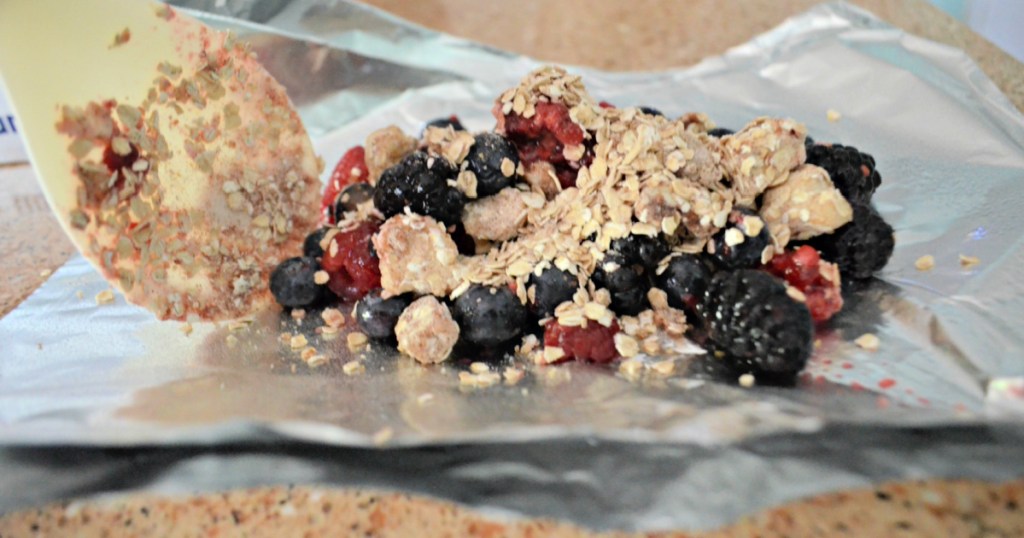 making a berry crisp in tin foil