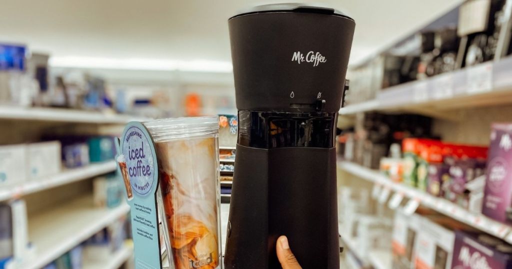 hand holding black coffee maker 