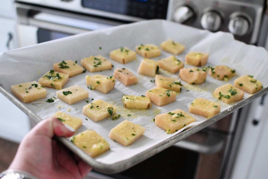 placing potatoes in the oven