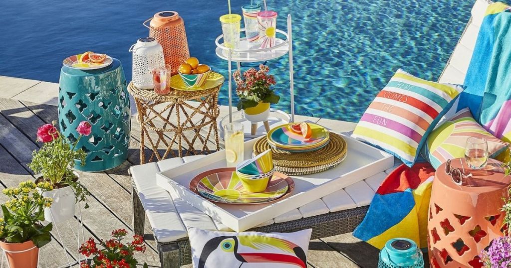 colorful lanterns and planters on deck by pool