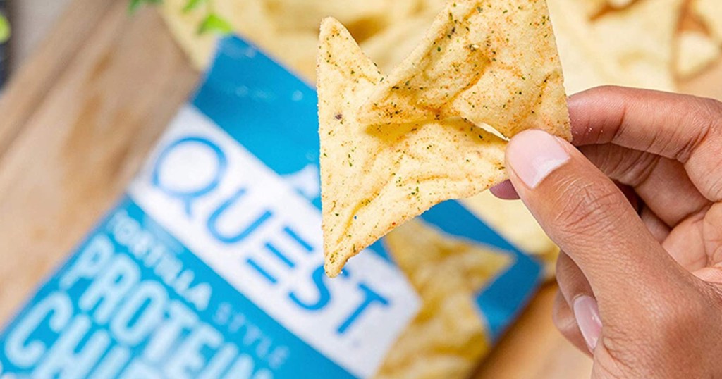 hands dipping in quest chip bag