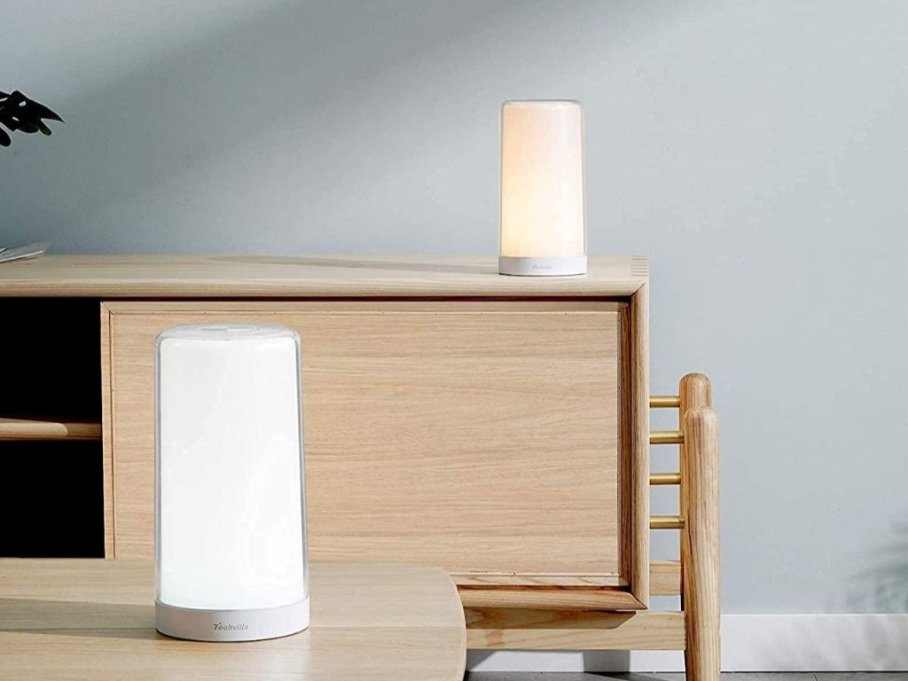 two lamps on a table and dresser